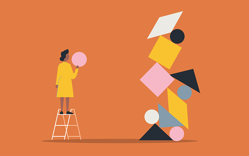 Illustration of person building with balanced shape blocks. CREDIT_istock-1322012019