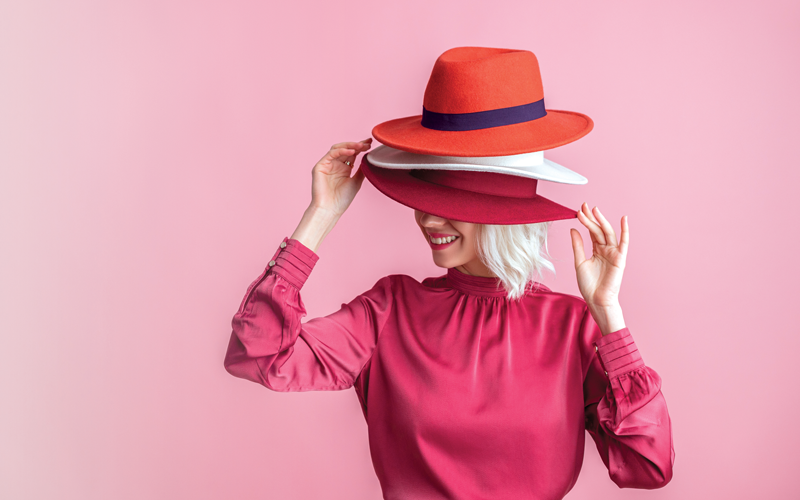 Happy smiling woman hides her face under many hapy.CREDIT_shutterstock_1959102688